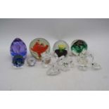 A collection of vintage glass paperweights and ornaments