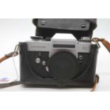 A Leitz Leica flex SL 35mm SLR camera, serial #1260207, with lens cap and carry case