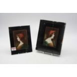 A pair of early 20th century head and shoulder busts of young women, reverse painted on glass,