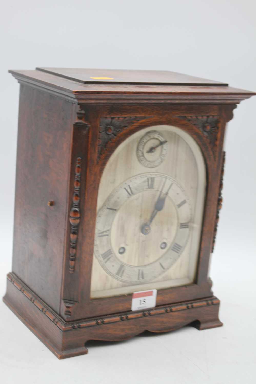 An early 20th century oak cased 8-day mantel clock, the slow/fast dial above a silvered chapter ring