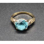 A yellow metal, blue zircon and white sapphire set dress ring, stamped and tested as 14ct, 3.5g,
