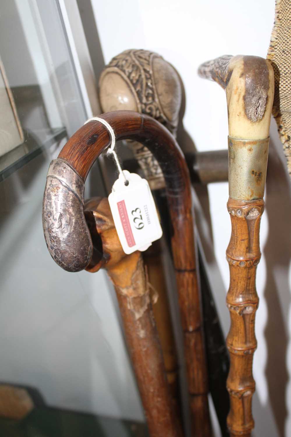 A collection of five 19th century and later walking sticks, to include a silver handled example,