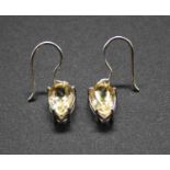 A pair of contemporary white metal and pear shaped four claw citrine set ear pendants, on shepherd's