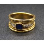 An 18ct gold, sapphire and diamond set tapering band ring, having ropetwist tramline borders, with