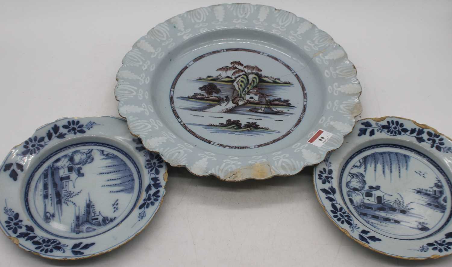 An 18th century Bristol Delftware charger, sapro bianco sapro decorated to the border, dia. 36cm,