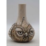 A pottery vase, relief decorated with grotesque owl masks, h.13cm