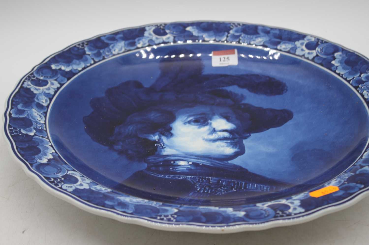 A Delft pottery charger, decorated with a Renaissance style bust of a gentleman, dia. 42cm