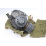 A military issue gas mask, in green canvas carry case