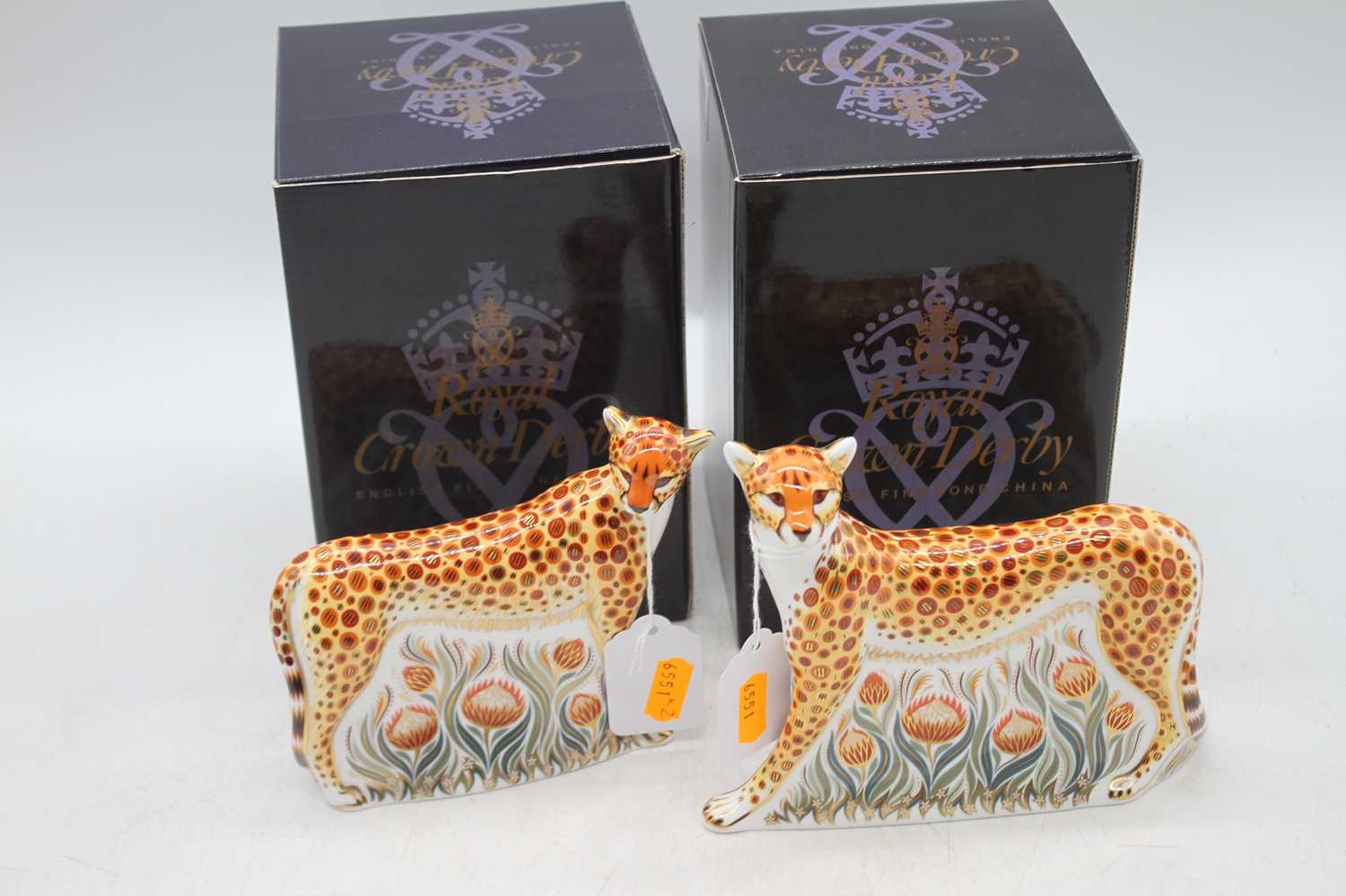 A Royal Crown Derby model of a cheetah daddy, Gold button h.14cm; together with another of a