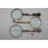 A mother of pearl handled table magnifying glass, 25cm; together with two others similar
