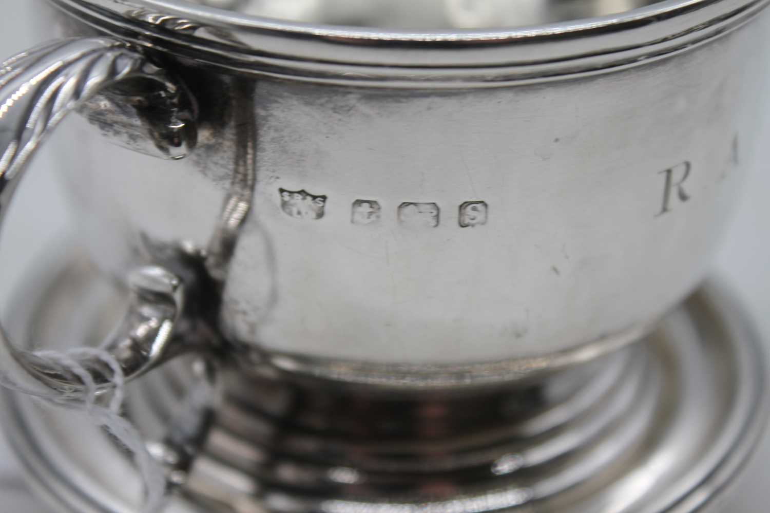 A George V silver cup having twin leaf capped scrolling handles, engraved RAJ within a raised - Image 2 of 3