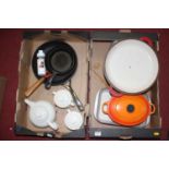 A collection of Le Creuset enamel cooking pans, dishes, and teawares