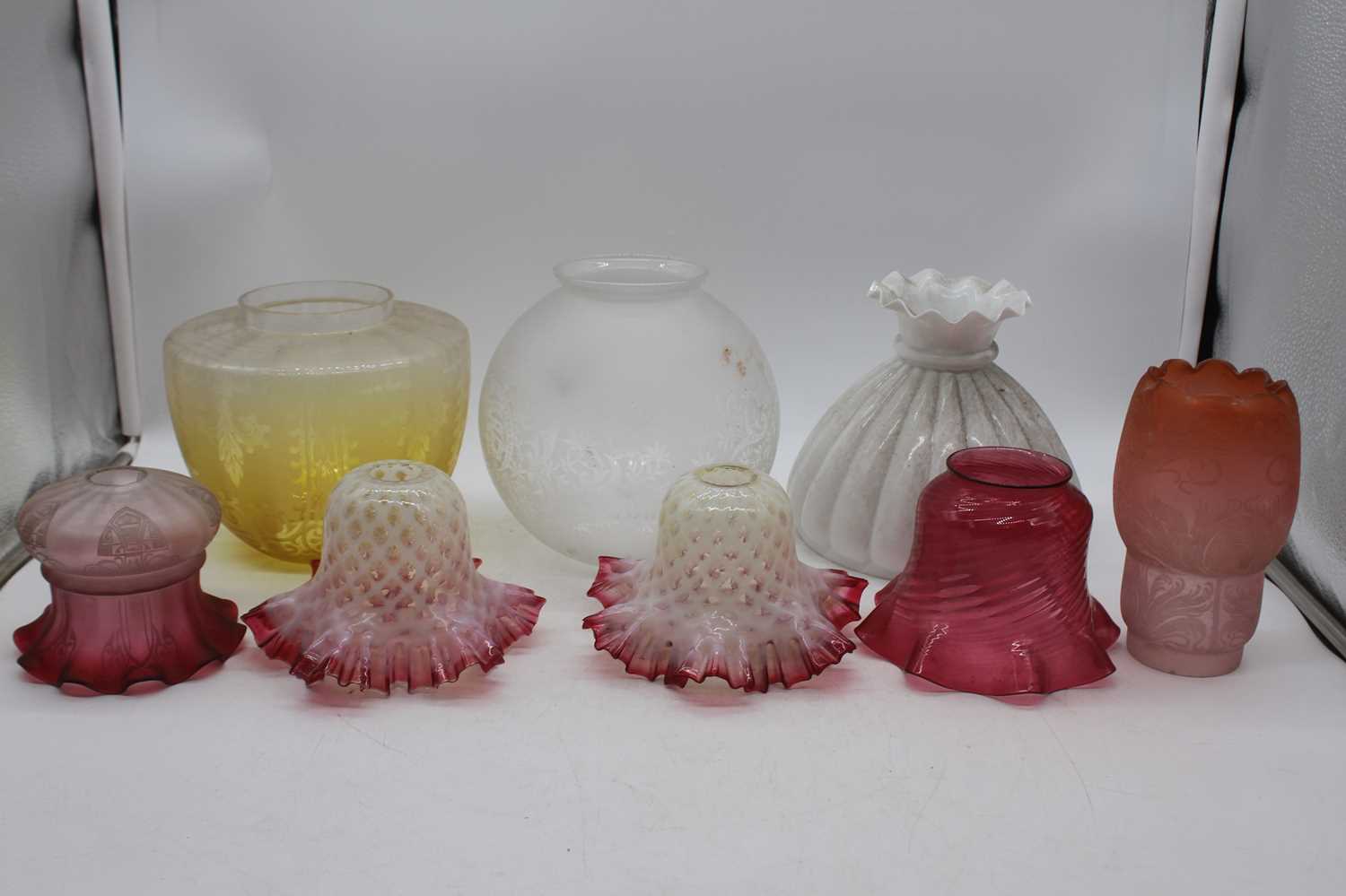 A collection of 19th century and later glass oil lamp shadesTwo floral white with cranberry - Image 2 of 2