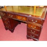 A reproduction mahogany twin pedestal writing desk, having a gilt tooled green leather inset surface