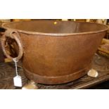 A contemporary rusted iron oval twin handled log bucket, width 74cm