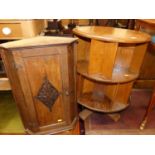 An oak circular revolving two-tier table, dia. 51cm, together with an oak single door hanging corner