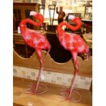 A pair of contemporary spray painted and pressed metal standing model flamingoes, each height 64cm