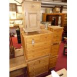 A modern pine bedroom furniture to include; a pair of chests of two short over three long drawers,