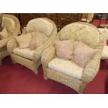 A contemporary wicker conservatory suite comprising two seater sofa, pair of armchairs, and glass