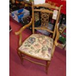 An Edwardian mahogany and satin wood inlaid pierced splat back elbow chair with floral tapestry