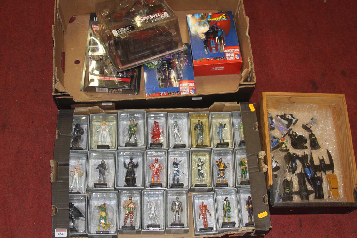 A collection of DC and Marvel related action figures to include Spawn The Classic Comic covers