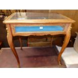 A French stained beech and gilt metal mounted hinge top bijouterie table, raised on slender cabriole