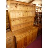 A modern stained boarded pine kitchen dresser, width 136.5cm