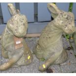 A pair of reconstituted stone garden figures modelled as seated hares, height 52.5cm