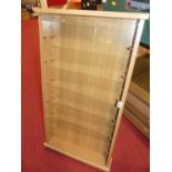 Five various light oak and beech effect glazed front display cases with removable shelves