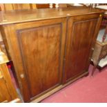 A 19th century mahogany side cupboard, having twin recessed panelled sliding cupboard doors, width