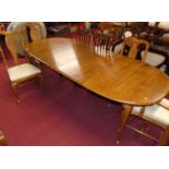 A contemporary American cherry wood dining suite comprising D-end extending dining table having a