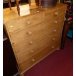 A Victorian pine chest of two short over four long graduated drawers on flattened bun supports,