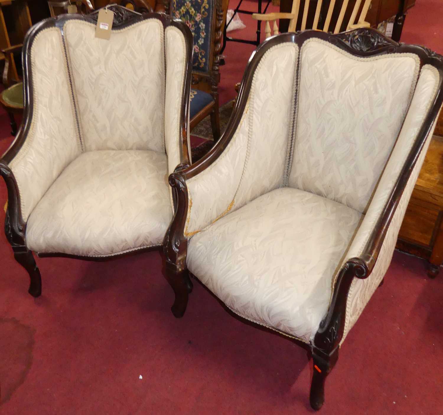 A pair of late Victorian carved mahogany framed and cream needlework fabric upholstered tub