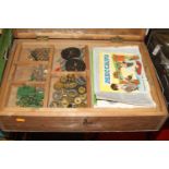 A wooden chest containing a quantity of 1950s red & green Meccano