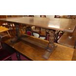 A joined oak refectory dining table having cleated ends raised on octagonal notched end supports,