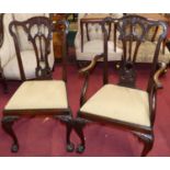 A set of four early 20th century floral pierced and carved mahogany Chippendale style dining chairs,