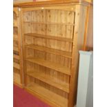 A modern pine round cornered free standing open bookshelf, width 137cm