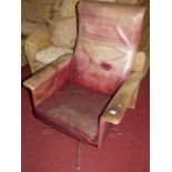 A 1960s faded vinyl swivel armchair, raised on chromed metal four spoke base, width 76cm