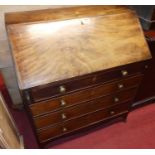 An early 19th century mahogany slope front four drawer writing bureau, having a fitted interior,