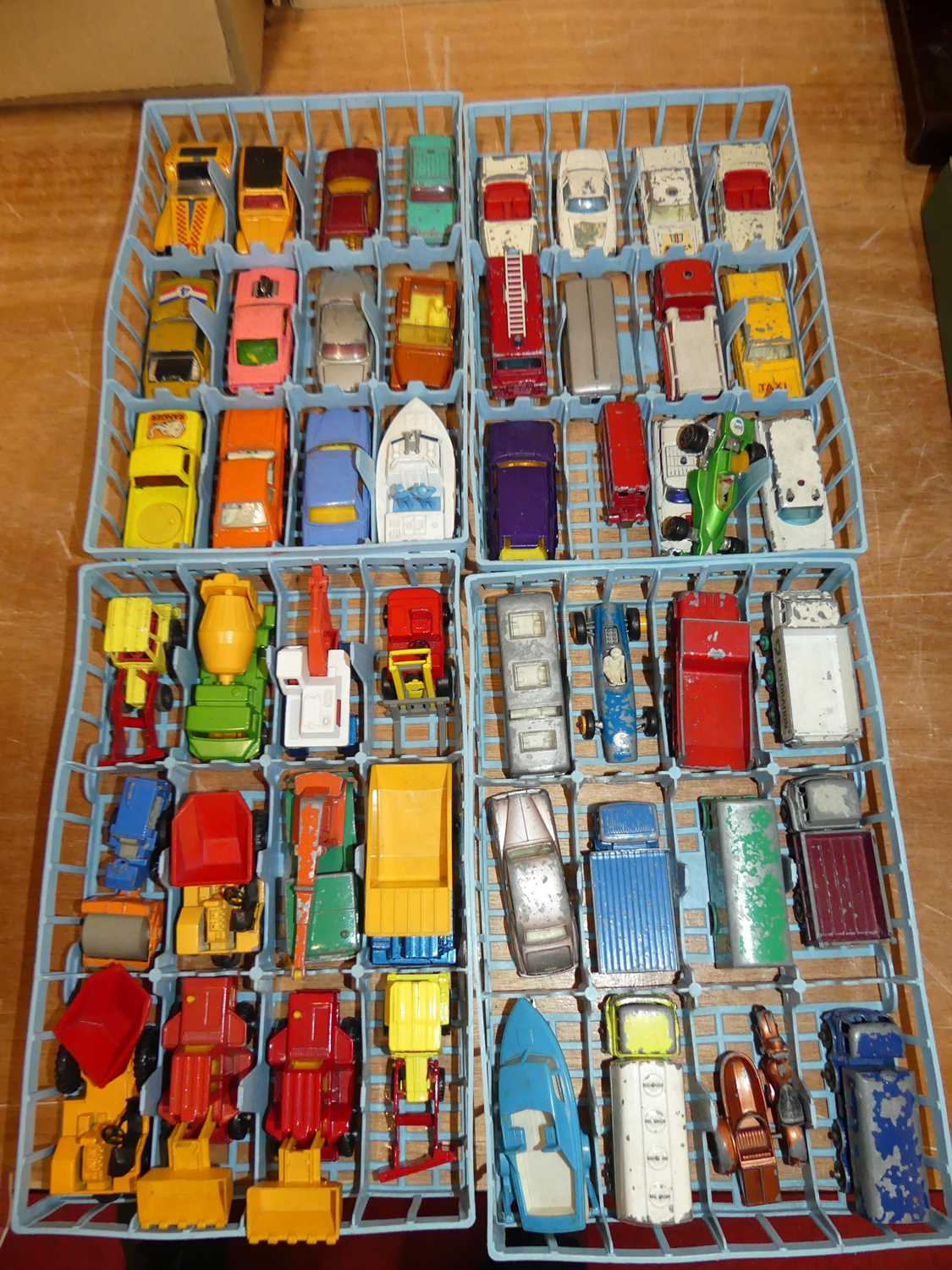 Four 12-section plastic Matchbox carry cases containing a collection of mixed playworn diecast