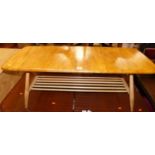 An Ercol light elm low coffee table having a laddered under tier, length 105cm