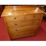 An Edwardian oak ledge back chest of two short over three long graduated drawers, to turned