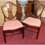 A set of six early 20th century mahogany Hepplewhite style dining chairs having pink upholstered