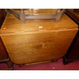 An oak drop leaf table having a gateleg action