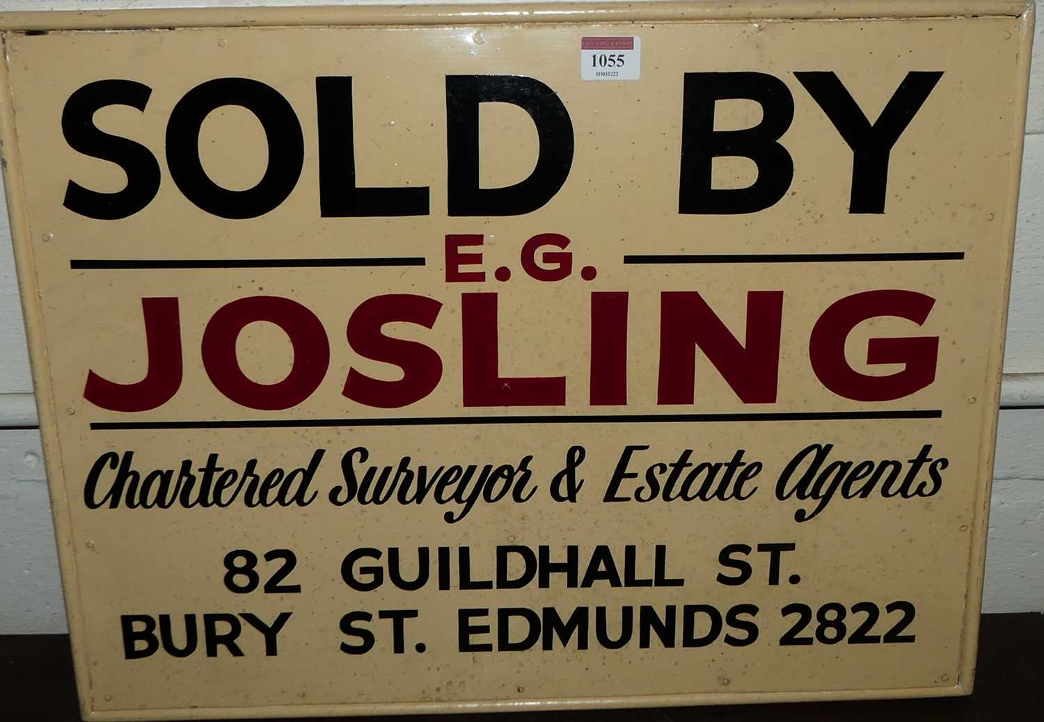 A hand-written wooden sign for E.G. Josling Chartered Surveyor & Estate Agents of Guildhall Street