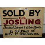 A hand-written wooden sign for E.G. Josling Chartered Surveyor & Estate Agents of Guildhall Street