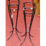 A pair of black painted wrought ice bucket stands, height 67.5cm