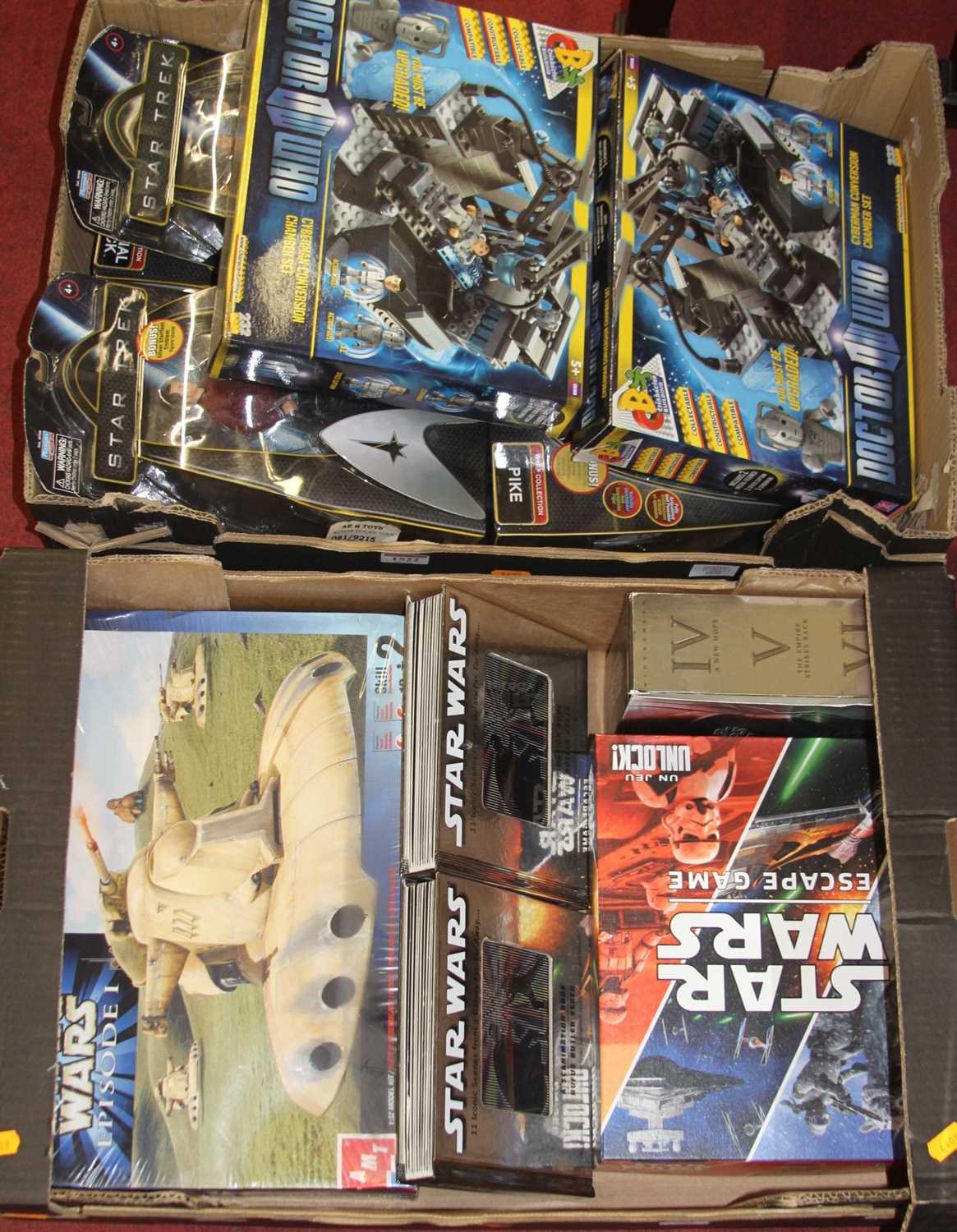 Two boxes of sci-fi related action figures and accessories to include Star Trek, Star Wars, and