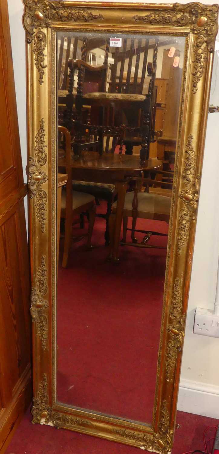 A late 19th century floral gilt wood and gesso framed rectangular wall mirror (some losses to floral