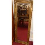 A late 19th century floral gilt wood and gesso framed rectangular wall mirror (some losses to floral